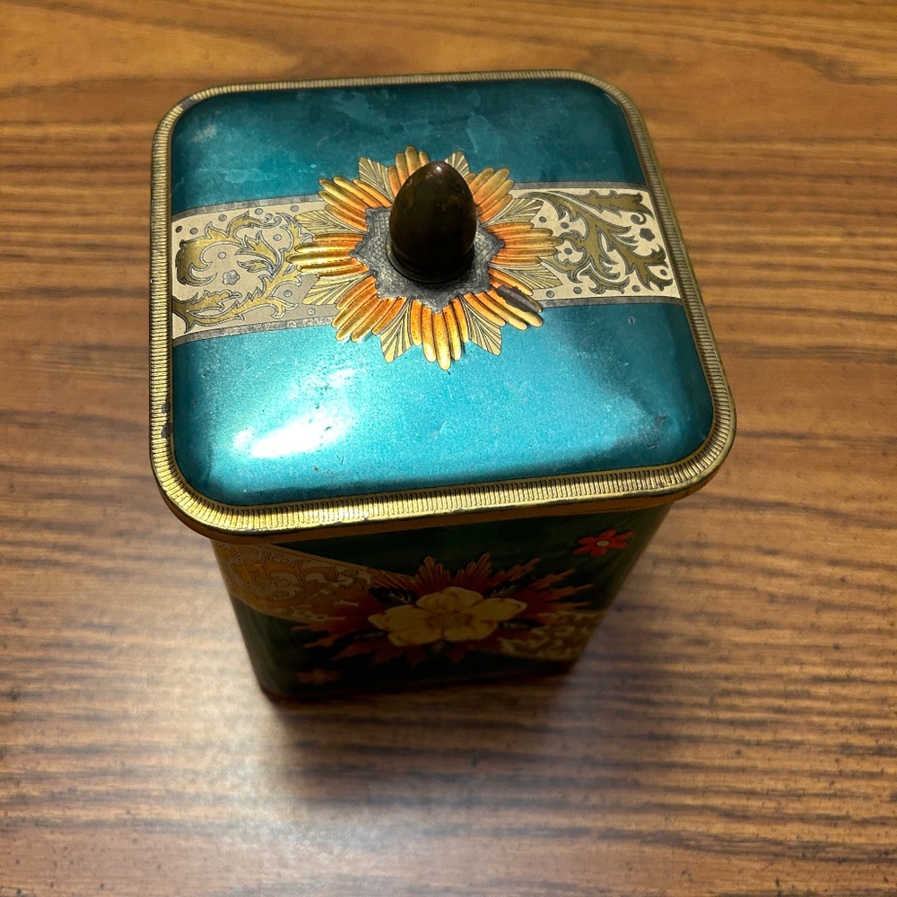Antique metal can with yellow flowers on all four sides, metal handle knob.